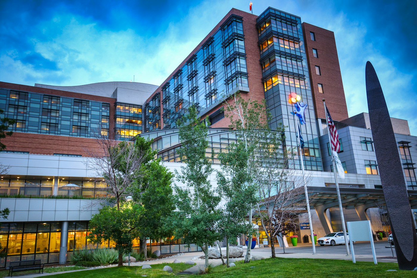 Hospital campus with a multi-story clinical building and landscaped entrance