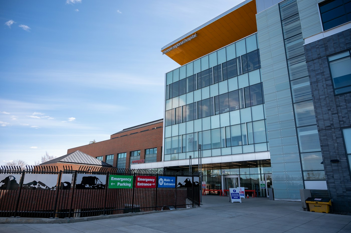 Chinook Regional Hospital exterior with a modern glass facade and marked hospital entrance